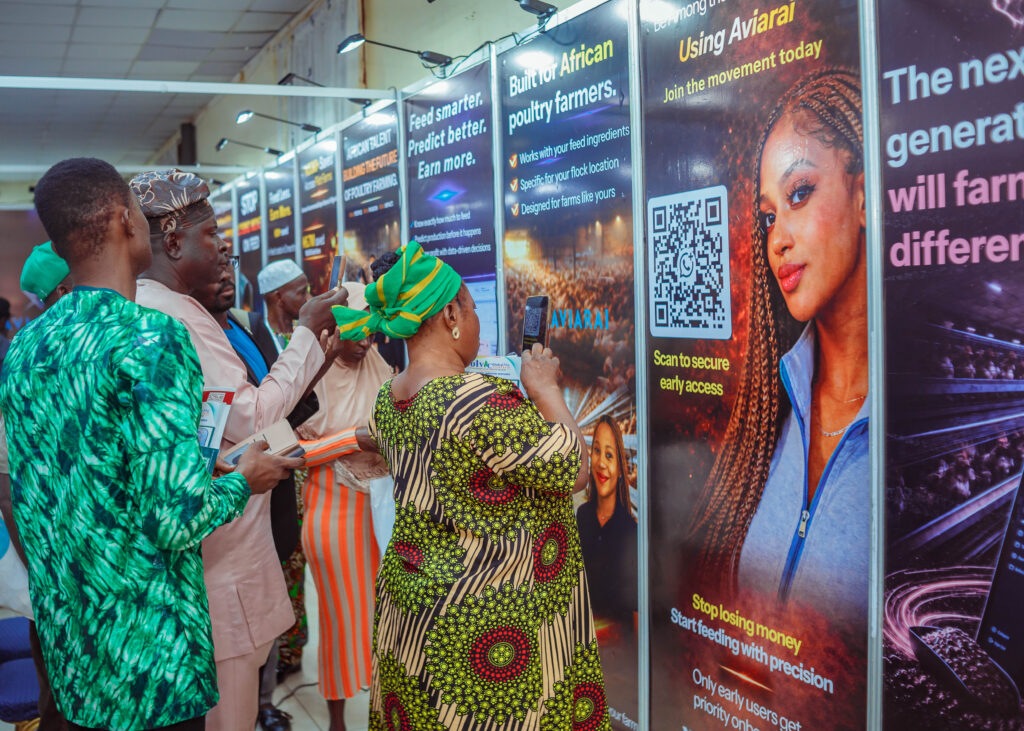 Poultry industry attendees scanning the Aviarai early-access QR code at an exhibition booth.